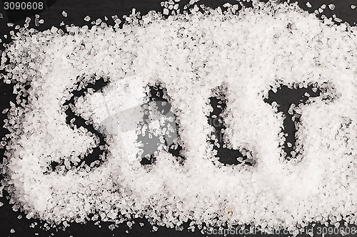 Image of The word salt written into a pile of white granulated salt