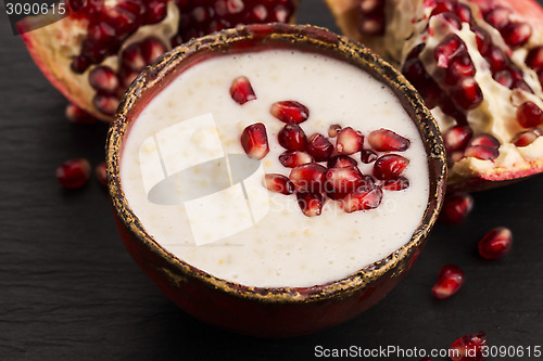 Image of Dish of banana millet breakfast pudding with pomegranate