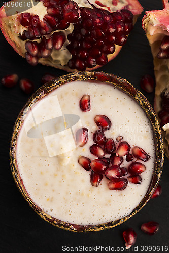 Image of Dish of banana millet breakfast pudding with pomegranate