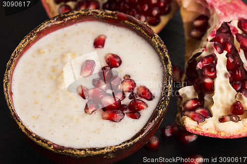 Image of Dish of banana millet breakfast pudding with pomegranate