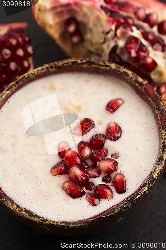 Image of Dish of banana millet breakfast pudding with pomegranate