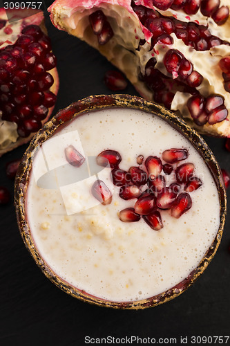 Image of Dish of banana millet breakfast pudding with pomegranate