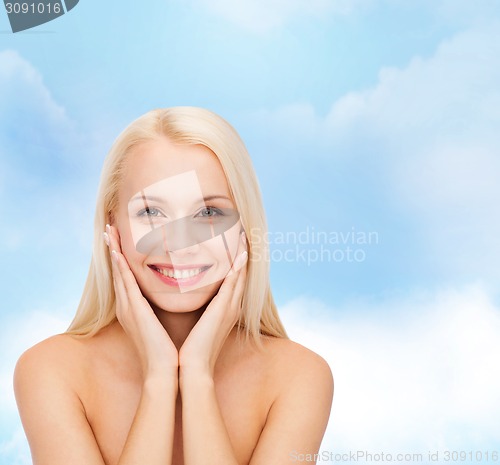 Image of beautiful woman touching her face skin