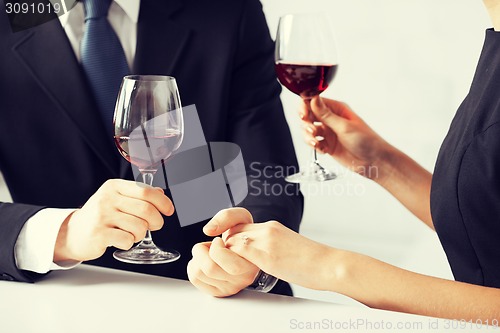 Image of engaged couple with wine glasses