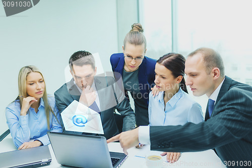 Image of business team with laptop having discussion