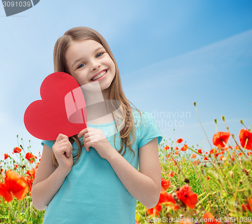 Image of smiling little girl with red heart