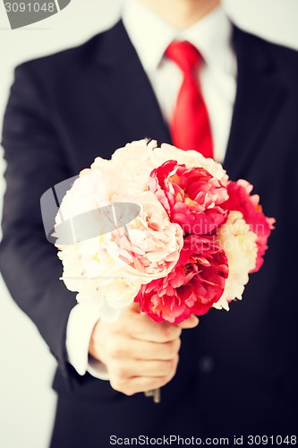 Image of man giving bouquet of flowers