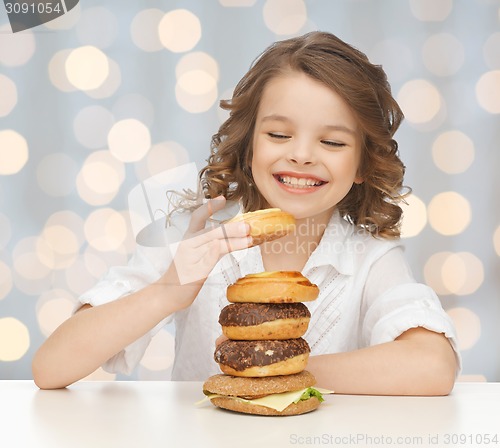 Image of happy smiling girl with junk food