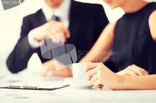 Image of woman hand signing contract paper