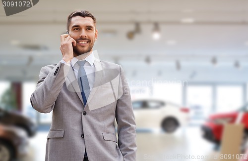 Image of smiling businessman talking on smartphone