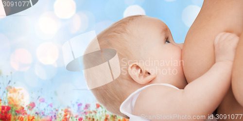 Image of close up of mother breast feeding adorable baby
