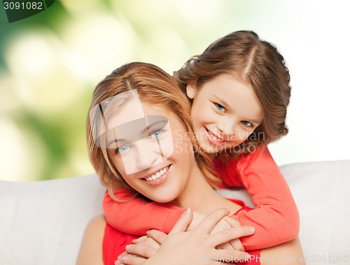 Image of happy mother with daughter hugging and talking