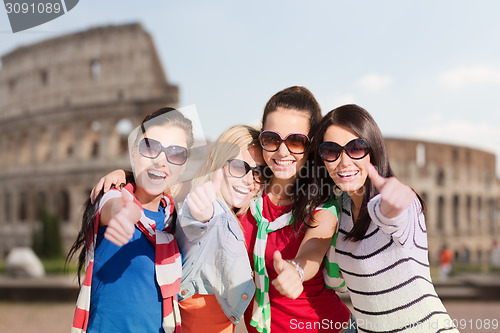 Image of happy teenage girls or women showing thumbs up