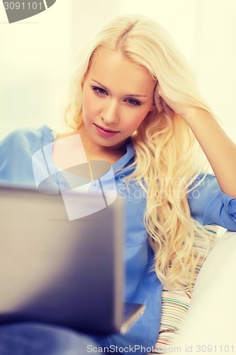 Image of woman with laptop computer at home