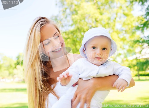 Image of happy mother with little baby in park