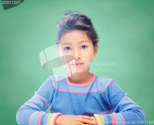 Image of little girl over chalk board background at school