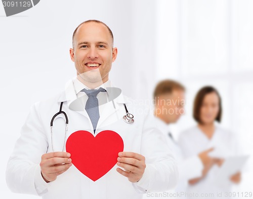 Image of smiling male doctor with red heart and stethoscope