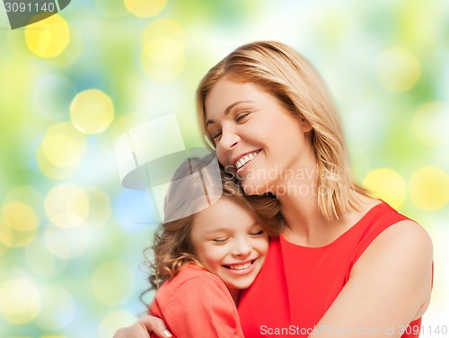 Image of happy mother and daughter hugging