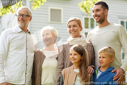 Image of happy family in front of house outdoors