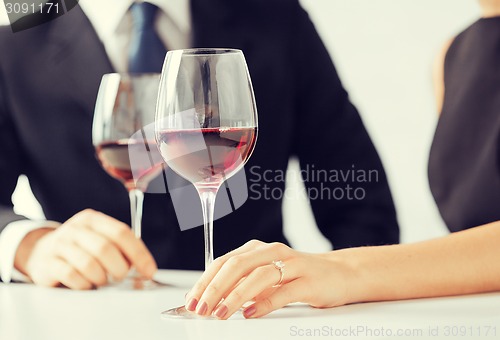 Image of engaged couple with wine glasses