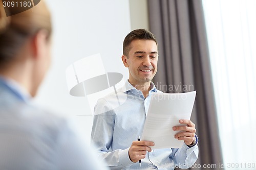 Image of smiling business people meeting in office