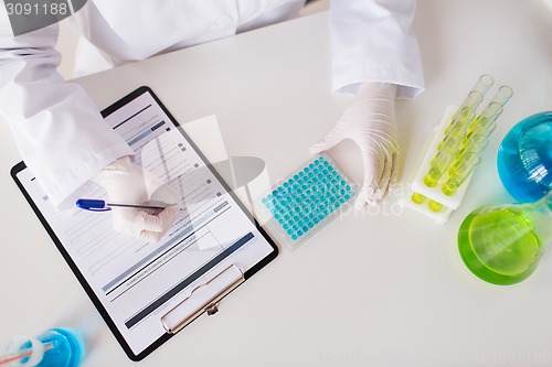 Image of close up of scientist making test in lab