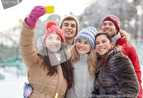 Image of happy friends taking selfie with smartphone