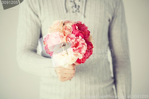 Image of man holding bouquet of flowers