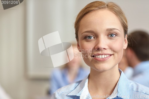 Image of group of smiling businesspeople meeting in office