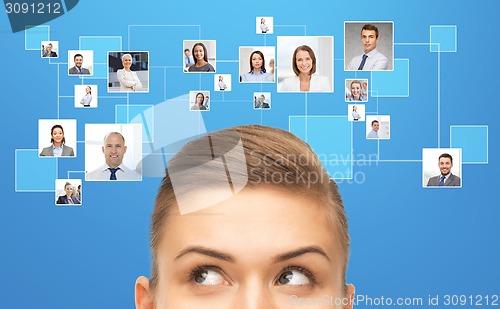 Image of close up of young woman looking for businesspeople