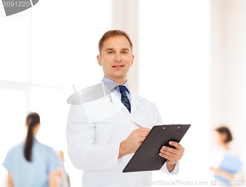 Image of smiling male doctor with clipboard