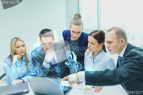 Image of business team with laptop having discussion