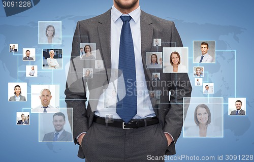 Image of close up of businessman over icons with contacts