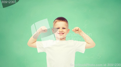 Image of happy little boy in white t-shirt flexing biceps