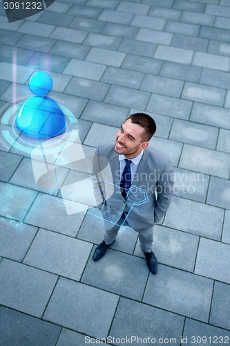 Image of young smiling businessman outdoors from top