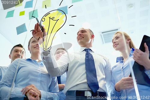 Image of smiling business people with marker and stickers