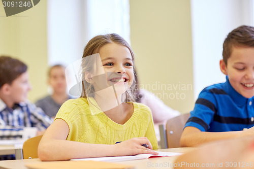 Image of group of school kids writing test in classroom