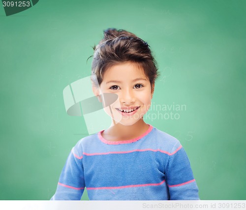 Image of little girl over chalk board background at school