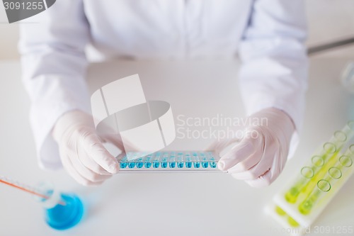 Image of close up of scientist making test in lab