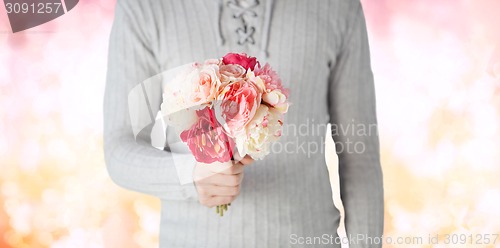 Image of close up of man holding flowers