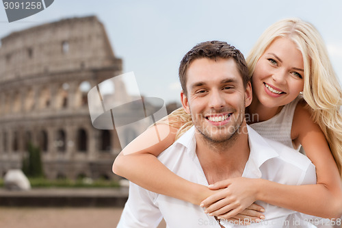 Image of happy couple hugging over coliseum