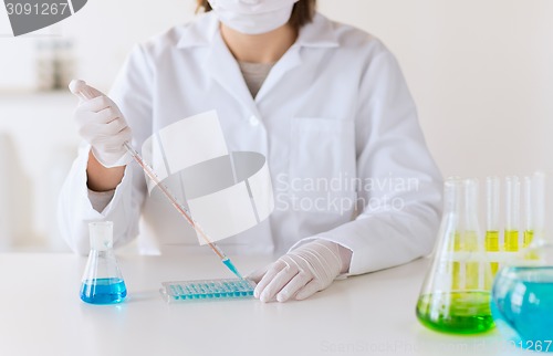 Image of close up of scientist making test in lab