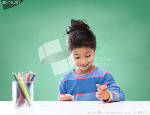 Image of happy school girl drawing with coloring pencils