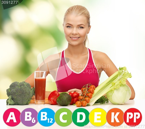 Image of happy woman with organic food and vitamins