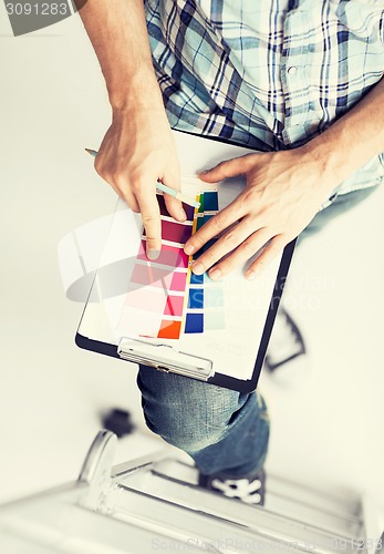 Image of man with color samples for selection