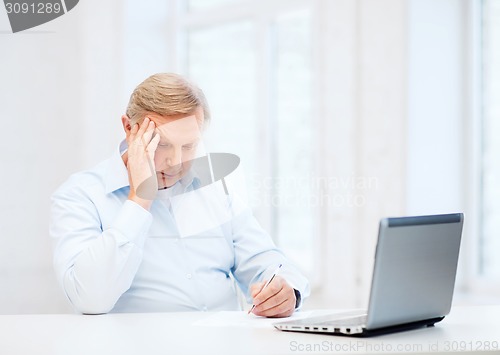 Image of old man filling a form at home