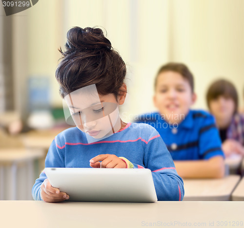 Image of little school girl with tablet pc over classroom