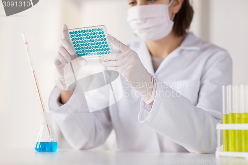 Image of close up of scientist making test in lab