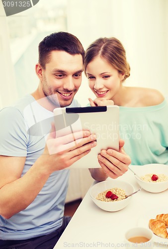 Image of smiling couple with taking picture with tablet pc