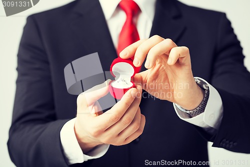 Image of man with wedding ring and gift box